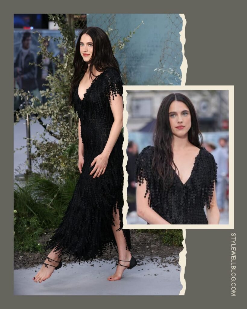 Margaret Qualley’s red carpet beauty look: effortless cascading waves, a clean no-makeup look, and contrasting black nail polish to match her dark Chanel aesthetic.