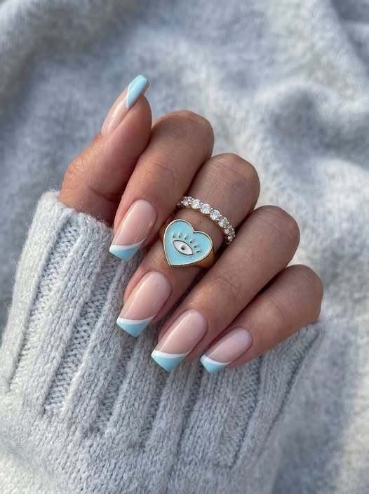 The shape of the nail is square with flat edges and subtle rounded corners to highlight the bold sky blue linear tip design.