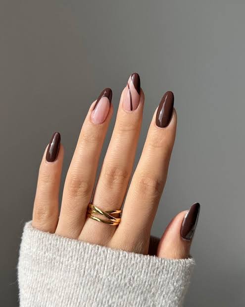 Thumb, index, and pinky nails exhibit espresso or dark chocolate color with a uniform look. Then the middle finger has a dramatic espresso French tip cutout curving smoothly along the free edge. And the ring finger features a curved brown blocking pattern split by a sharp, thin diagonal stripe.